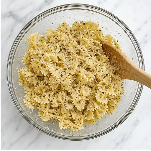 Step 2: Tossing pasta with seasonings and oil