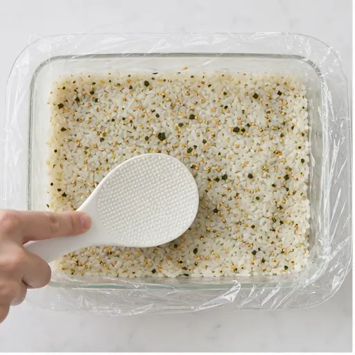 Step 1: Pressing seasoned rice into baking dish