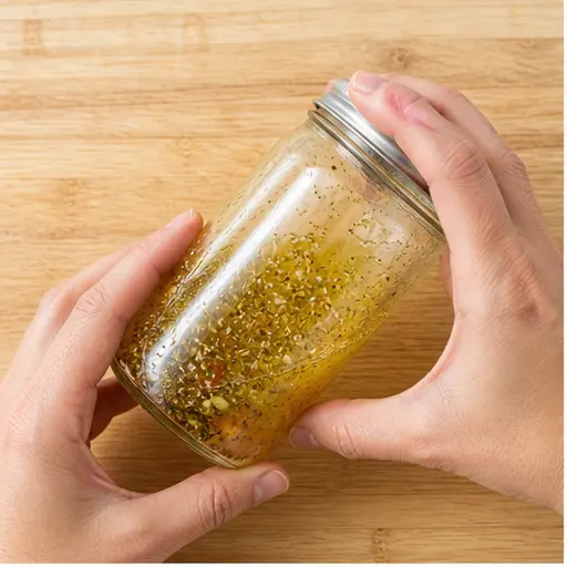 Step 1: Shaking the Greek vinaigrette in a jar