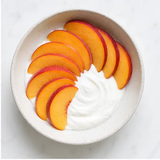 Step 2: Arranging fresh peach slices on yogurt