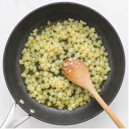 Step 1: Sautéing chopped onion and garlic