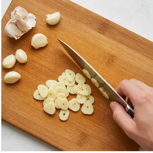 Step 2: Thinly slicing fresh garlic cloves