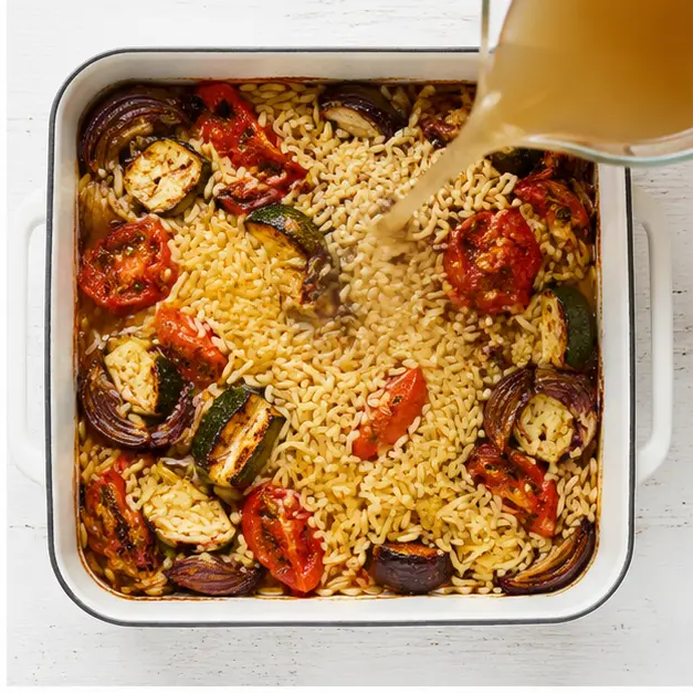 Step 2: Adding orzo and broth to roasted vegetables
