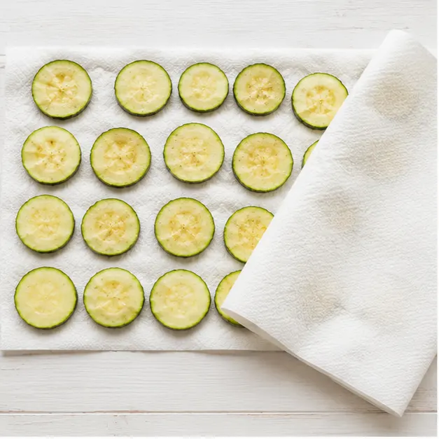 Step 1: Salting and drying zucchini rounds on paper towels to remove moisture