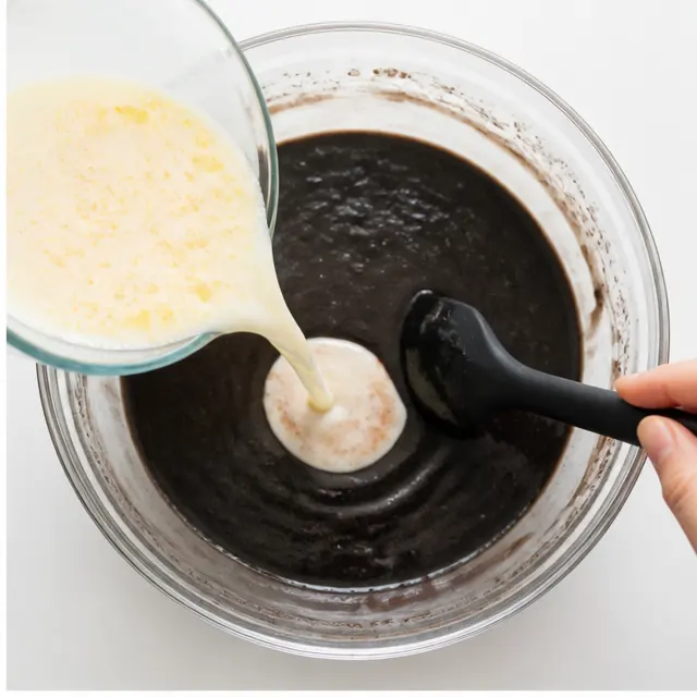 Mix wet ingredients into thin dark batter