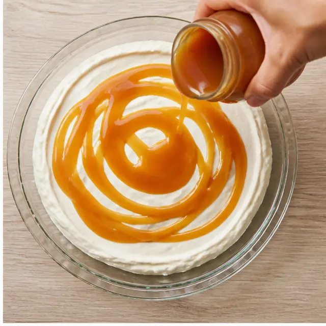 Step 2: Drizzle the caramel sauce generously over the cream cheese layer
