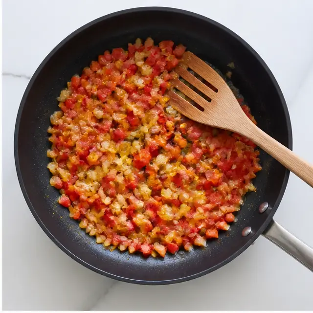 Stage 2: Sautéing diced bell pepper and yellow onion until softened and translucent