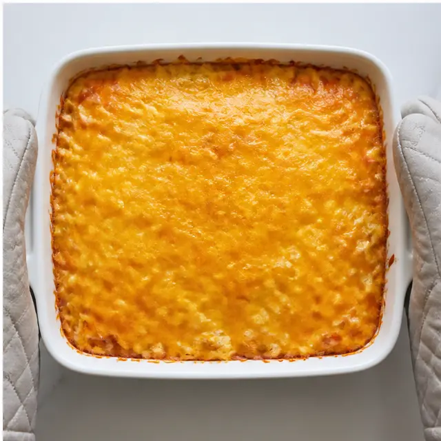 Stage 4: Baking until bubbly and topping with the remaining sharp cheddar until melted
