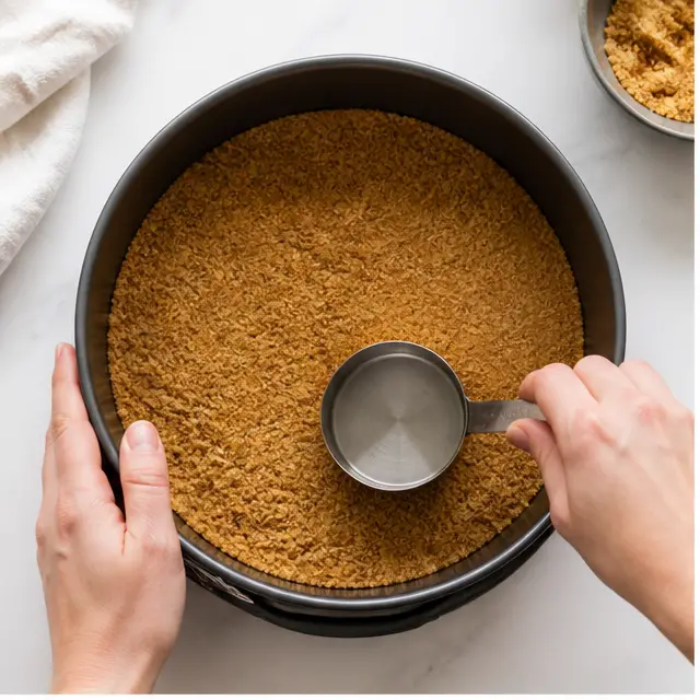 Step 1: Pressing the gingersnap crust into the springform pan