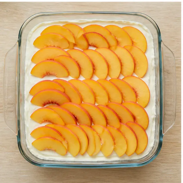 Step 3: Layering fresh peach slices over the cream filling
