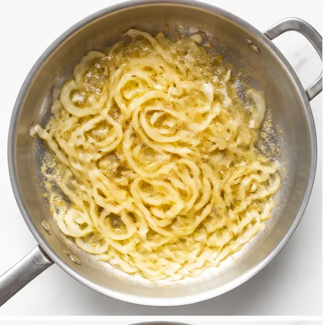 Step 1: Sauté sliced onions in butter until softened and golden