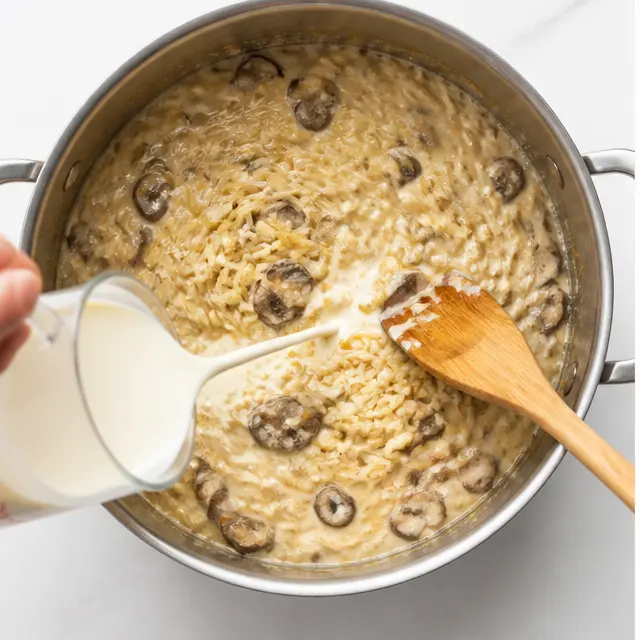 Step 3: Stir uncooked orzo into the creamy sauce to absorb the broth