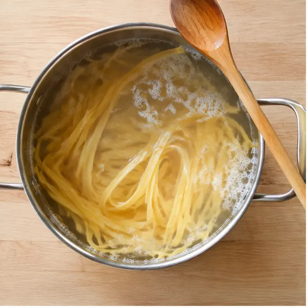 Step 1: Boiling fettuccine pasta in salted water until al dente