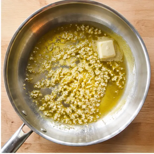 Step 2: Sizzling minced garlic and melting butter in olive oil
