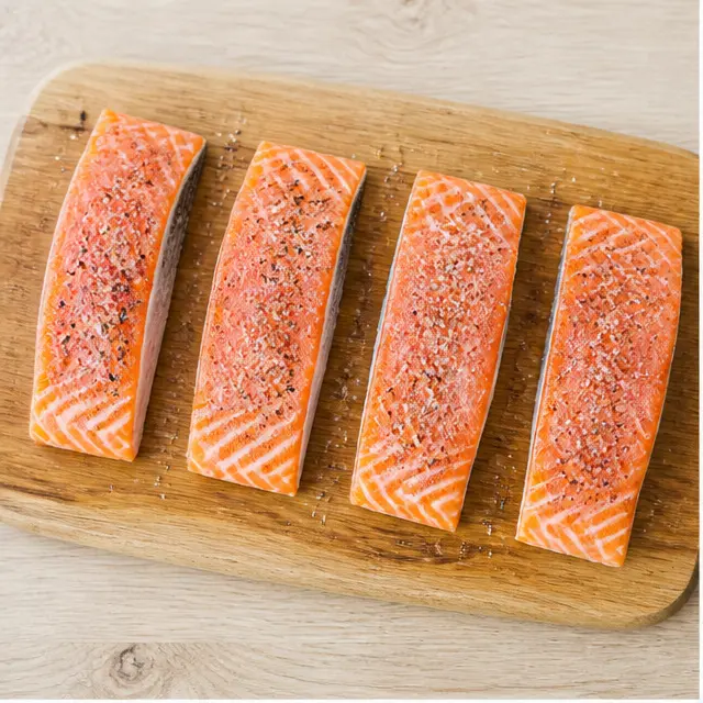 Step 1: Prepping and seasoning salmon fillets on a cutting board.