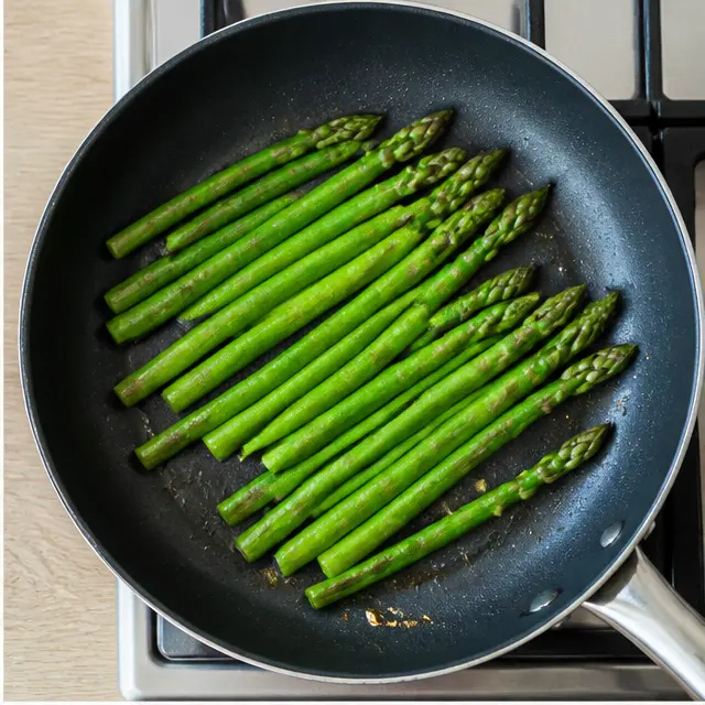 Step 2: Searing asparagus and salmon fillets in a large skillet.