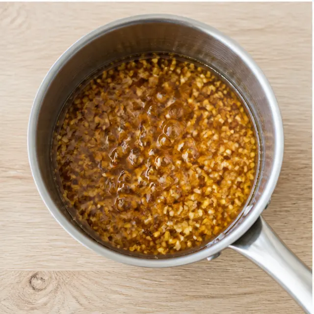 Step 3: Simmering the honey garlic butter sauce in a small saucepan.