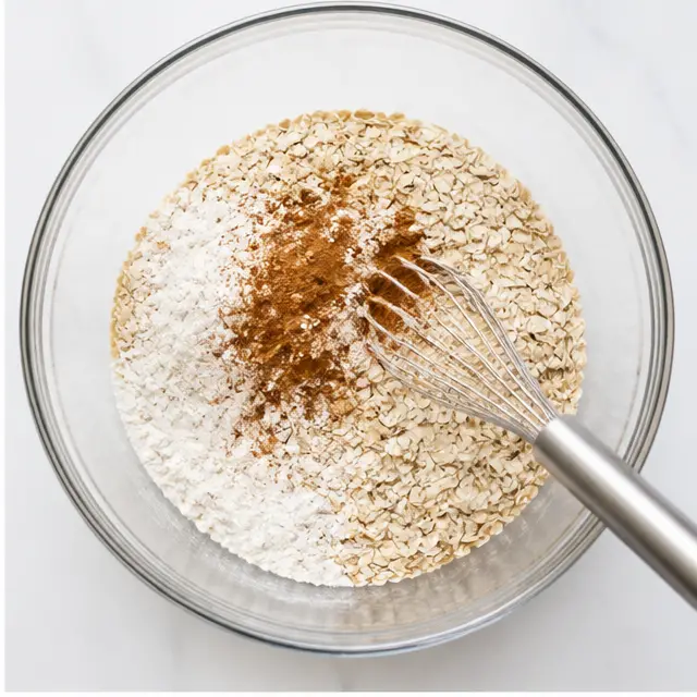 Whisk the rolled oats, flours, ground cinnamon, baking soda, and salt together.