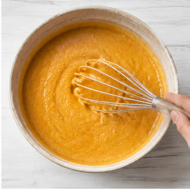Mixing the wet ingredients with pumpkin puree