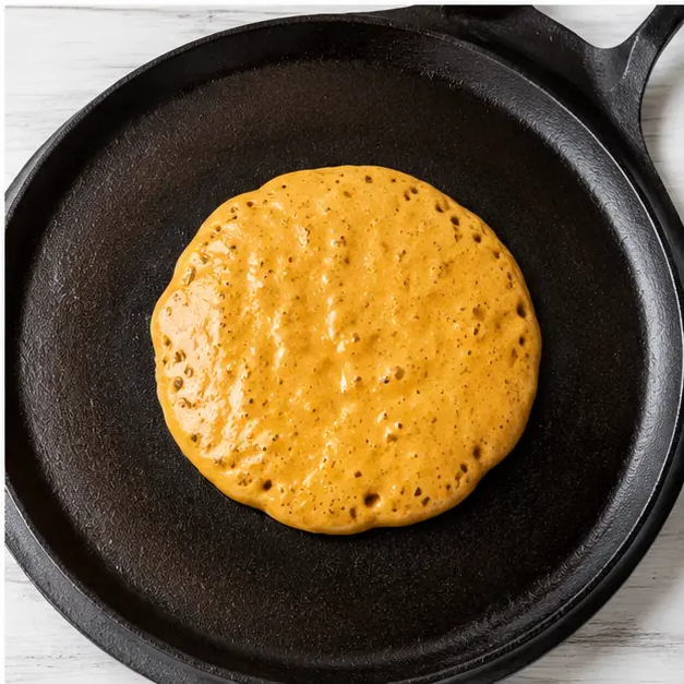 Cooking and flipping golden brown pancakes