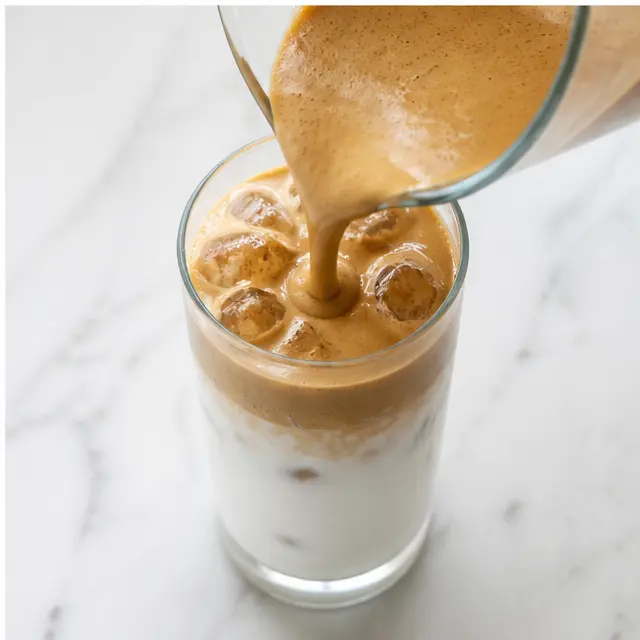 Step 4: Pour the frothed coffee over the iced milk and serve immediately.