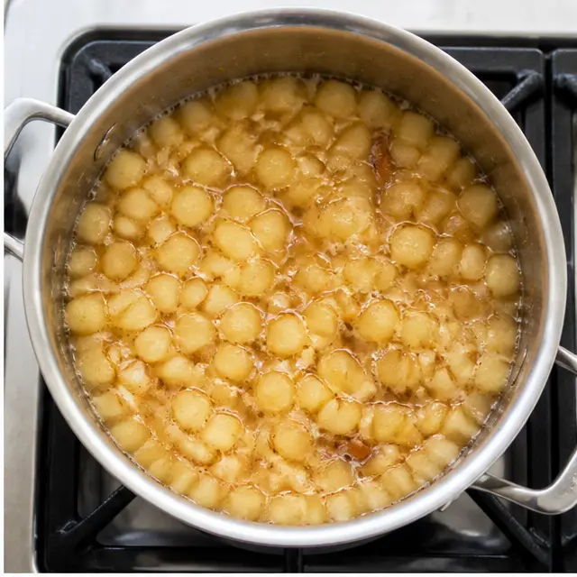 Step 2: simmering apples with sugar and spices on the stove