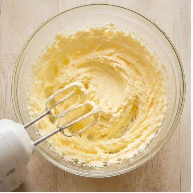 Cream softened butter and sugar into a smooth thick paste