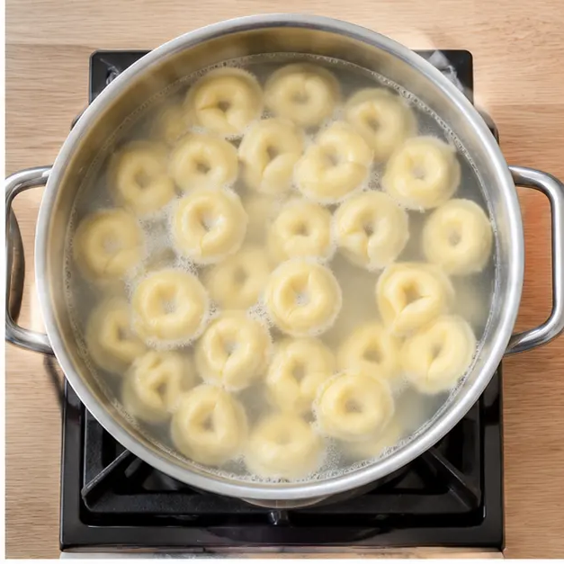 Step 2: Slide ring-shaped cheese tortellini in and cook about 1 and a half minutes until they float