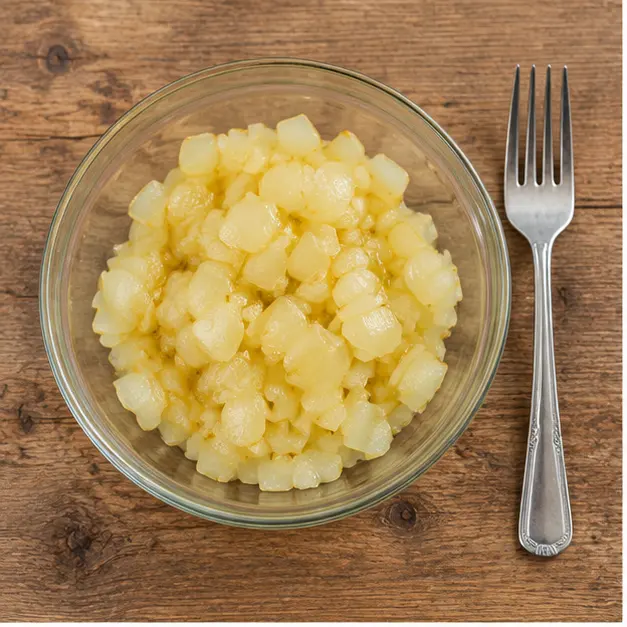 Step 1: Diced yellow onion softening in a glass bowl after microwaving