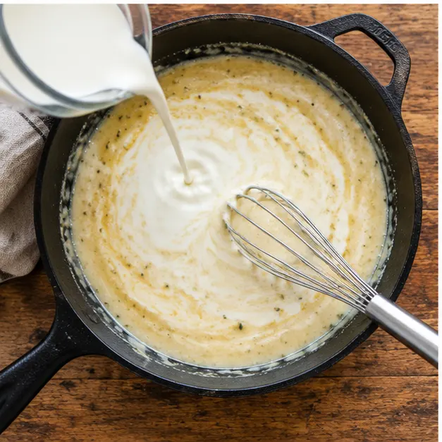 Step 3: Half-and-half poured in all at once while whisking into the paste